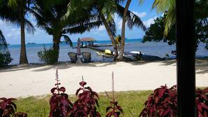 On the beach, white sand, sun loungers, beach towels