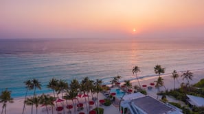 On the beach, white sand, sun loungers, beach towels