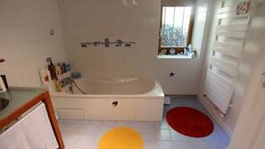 Separate bathtub and shower, deep-soaking bathtub, hair dryer, towels