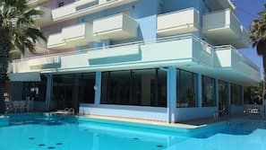 Seasonal outdoor pool, open 10:00 AM to 7:00 PM, pool umbrellas