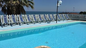 Seasonal outdoor pool, open 10:00 AM to 7:00 PM, pool umbrellas