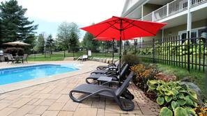 Seasonal outdoor pool, open 9:00 AM to 10:00 PM, pool umbrellas