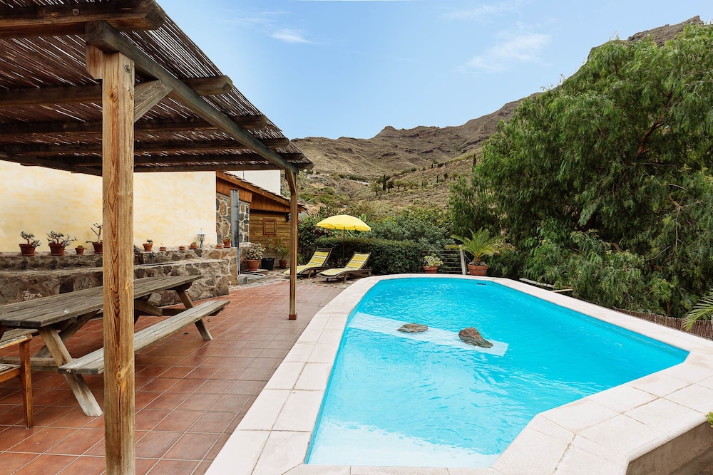 Villa with private pool in a valley under the sun and palms Tasarte