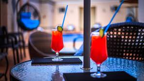 Outdoor pool, open 10:00 AM to 7:00 PM, pool umbrellas