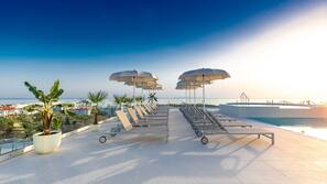 Indoor pool, seasonal outdoor pool, pool umbrellas, pool loungers