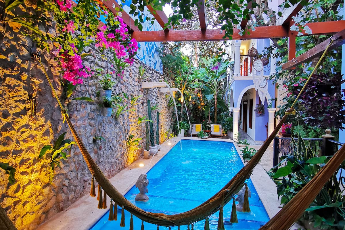 Le Muuch Hotel In Valladolid pool area with garden