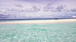 On the beach, white sand, sun-loungers