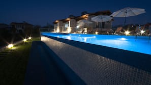 Seasonal outdoor pool, open 9:00 AM to 11:00 PM, pool umbrellas