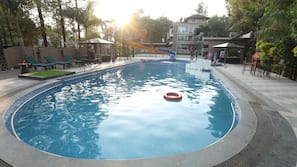 Outdoor pool, open 7:00 AM to 7:00 PM, pool umbrellas, pool loungers