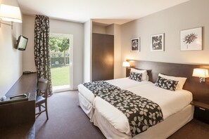 Premium bedding, laptop workspace, blackout drapes, soundproofing