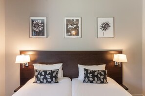 Premium bedding, laptop workspace, blackout drapes, soundproofing