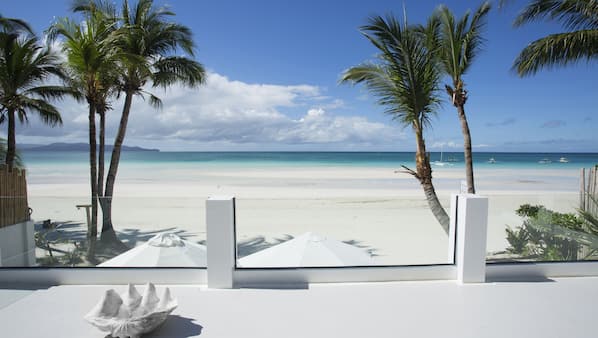On the beach, white sand, sun-loungers, beach umbrellas