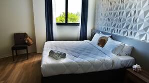 Premium bedding, laptop workspace, blackout drapes, soundproofing