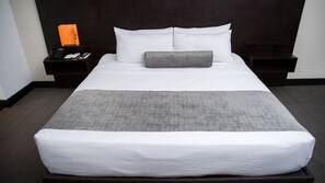 Premium bedding, desk, laptop workspace, blackout drapes