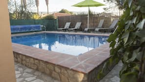 Seasonal outdoor pool, open 7:00 AM to 10:00 PM, pool umbrellas
