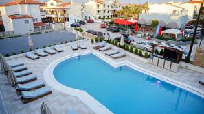 Seasonal outdoor pool, pool umbrellas, pool loungers