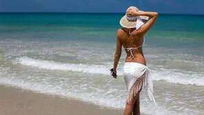 On the beach, sun loungers, beach umbrellas, windsurfing