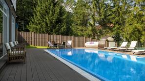 Seasonal outdoor pool, open 7:00 AM to 7:00 PM, pool umbrellas