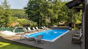 Seasonal outdoor pool, open 7:00 AM to 7:00 PM, pool umbrellas