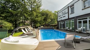 Seasonal outdoor pool, open 7:00 AM to 7:00 PM, pool umbrellas