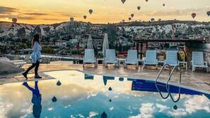 Seasonal outdoor pool, open 10:30 AM to 7:00 PM, pool umbrellas