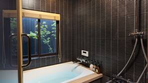 Combined shower/tub, free toiletries, hair dryer, slippers