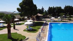 Seasonal outdoor pool, open 11:00 AM to 7:30 PM, pool umbrellas