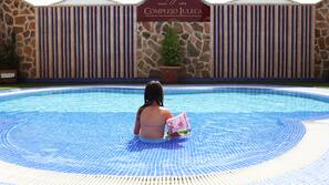 Seasonal outdoor pool, open 11:00 AM to 7:30 PM, pool umbrellas