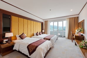 Deluxe Triple Room | Minibar, desk, laptop workspace, blackout drapes