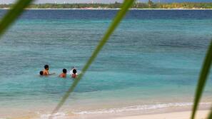 On the beach, white sand, sun-loungers, beach umbrellas