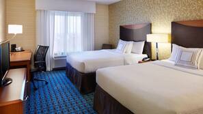 Premium bedding, desk, laptop workspace, blackout drapes