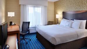 Premium bedding, desk, laptop workspace, blackout drapes