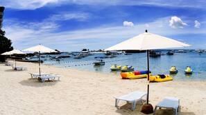 On the beach, white sand, sun loungers, beach towels