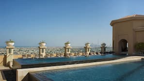 2 outdoor pools, open 7:00 AM to 10:00 PM, pool loungers