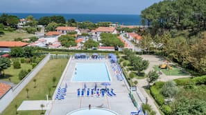 Piscine extérieure, parasols de plage, chaises longues
