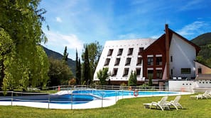 Una piscina al aire libre de temporada, tumbonas