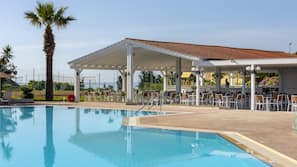 Piscine extérieure, parasols de plage, chaises longues