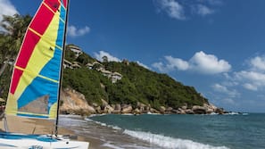 On the beach, white sand, free beach cabanas, beach towels