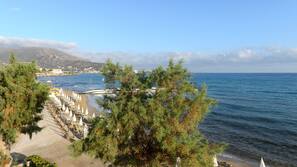 White sand, sun-loungers, beach umbrellas, beach towels