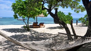 On the beach, white sand, sun-loungers, beach umbrellas