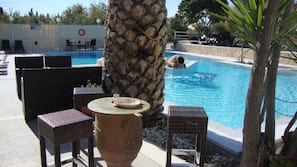 Seasonal outdoor pool, pool loungers