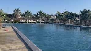 Outdoor pool, a heated pool, open 9:00 AM to 9:00 PM, pool umbrellas