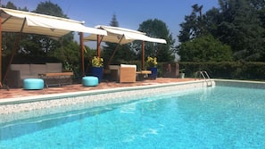 Seasonal outdoor pool, open 9:00 AM to 8:30 PM, pool umbrellas