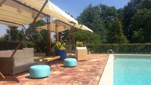 Seasonal outdoor pool, open 9:00 AM to 8:30 PM, pool umbrellas