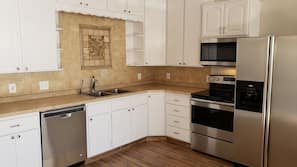 Full-size fridge, oven, stovetop, cookware/dishes/utensils