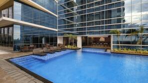 Outdoor pool, pool loungers, lifeguards on site