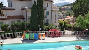 Piscina stagionale all'aperto, ombrelloni da piscina, lettini