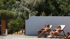 Seasonal outdoor pool, open 10:00 AM to 7:00 PM, pool umbrellas