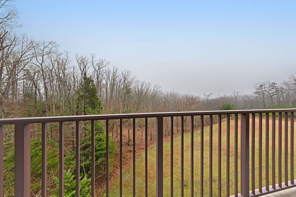 Luxury condo w/ forest & mountain views, a private balcony, & covered parking!