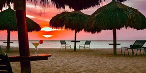 On the beach, white sand, free beach cabanas, beach umbrellas